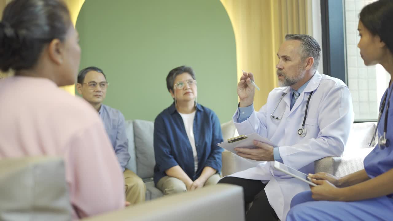 4K资深医生在医院与一群老年病人讨论视频素材