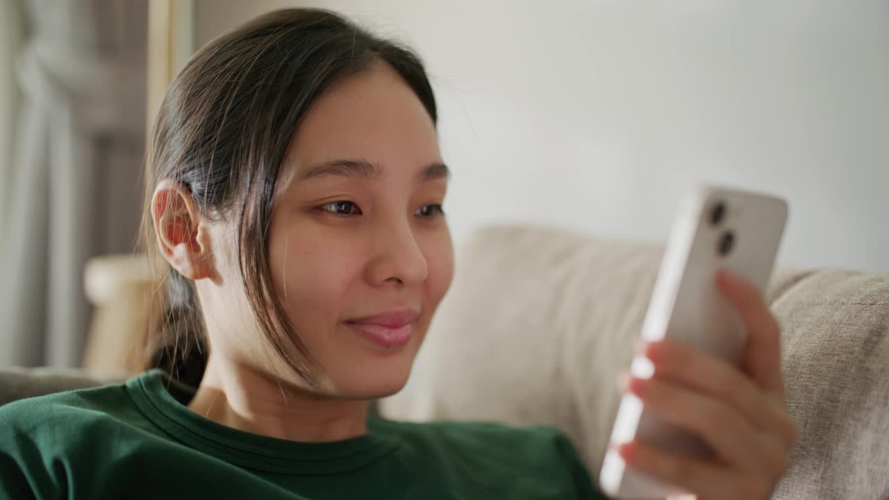 妇女在家里使用智能手机视频素材