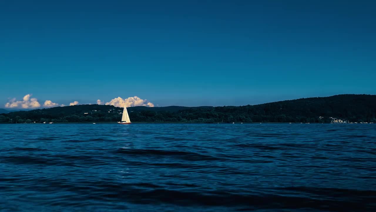 慢动作和低角度的小船航行在平静的开放的马乔雷湖在意大利的湖水视频素材