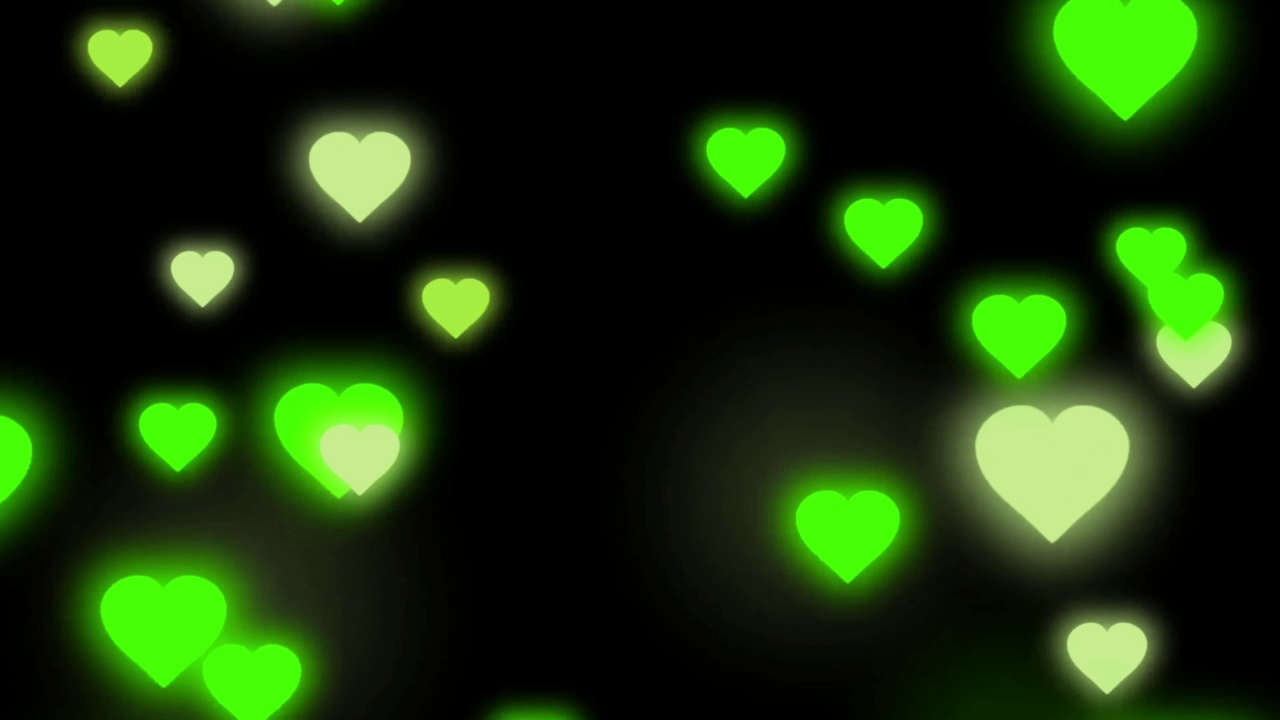 动画绿色心形分离漂浮在黑色背景的情人节。视频下载