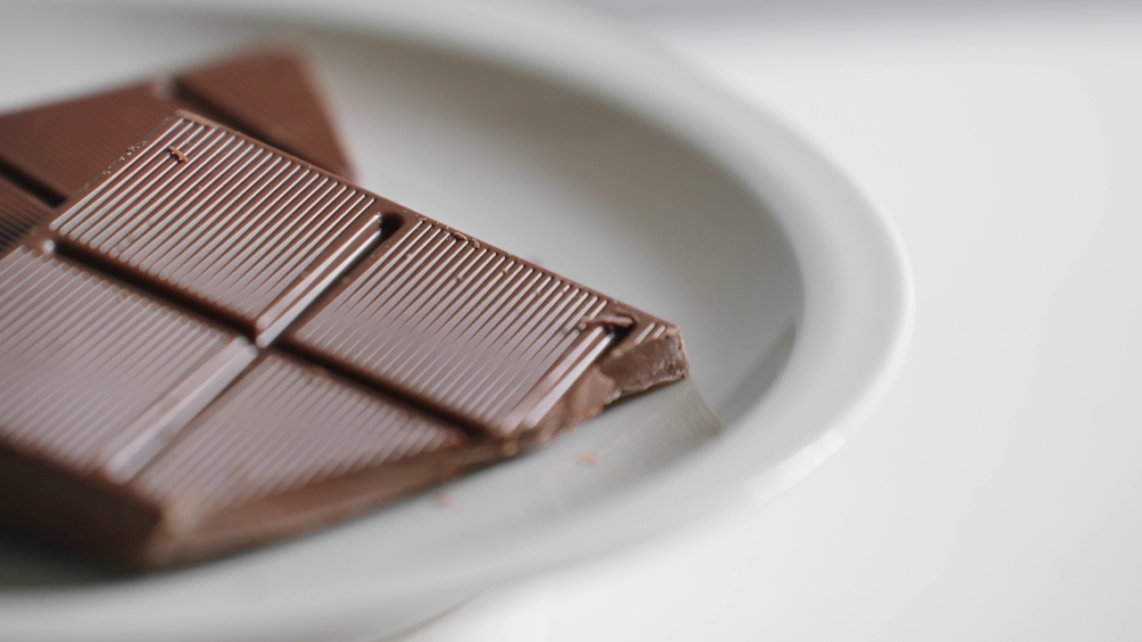 在旋转木马上，一块块的巧克力单独放在一个白色盘子上视频素材