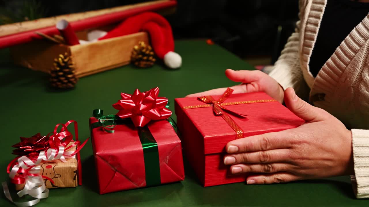 特写一个女人堆叠礼品盒一个接一个，为圣诞节，新年或任何其他庆祝活动。节礼日视频下载