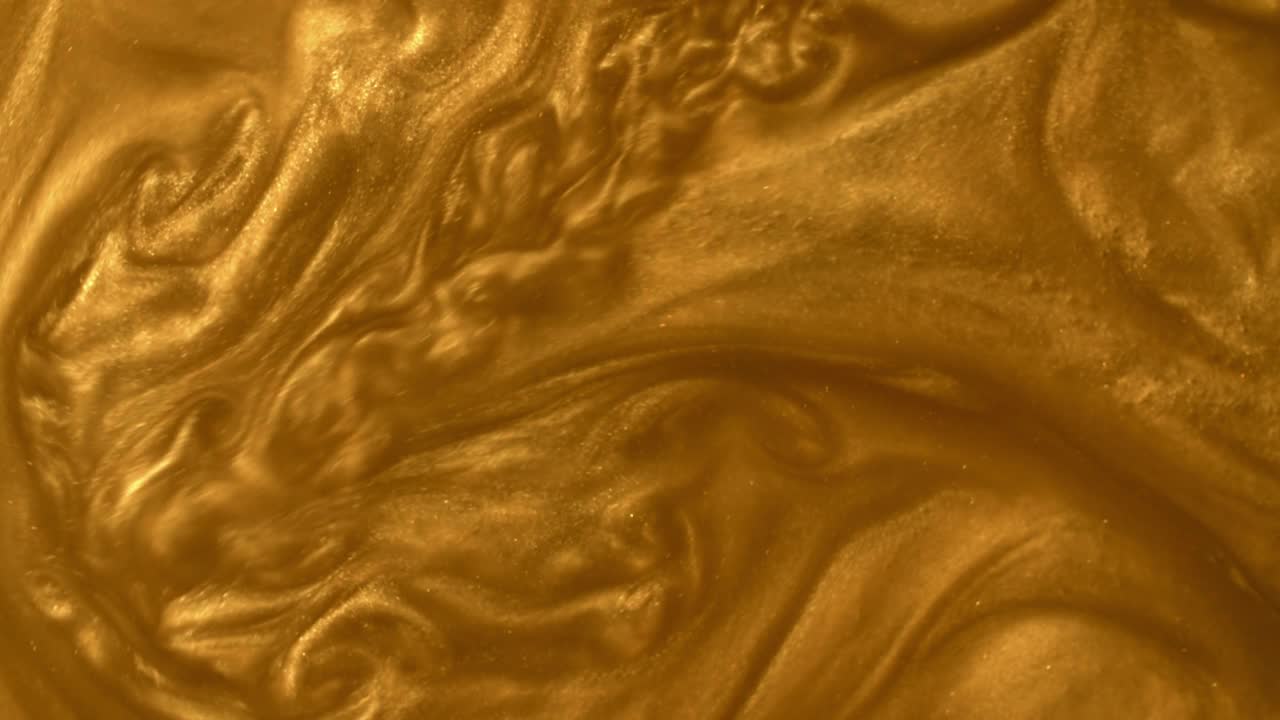 液体金色表面与闪闪发光的颗粒。金色的砂层，橙色的金属质感视频下载