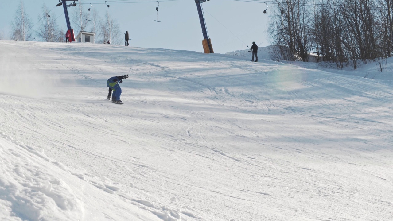 一个滑雪者从斜坡上滑下来，表演一个三脚架的把戏，然后摔在斜坡上视频素材