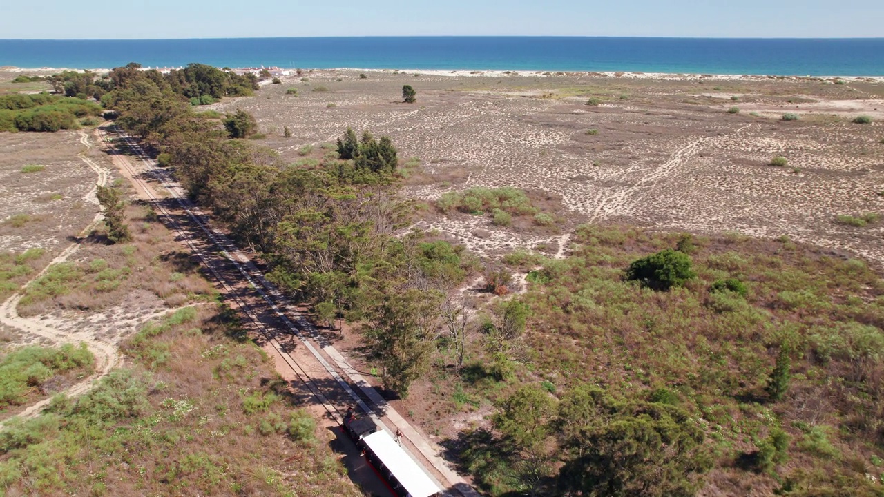 航拍到葡萄牙阿尔加维巴里尔海滩的复古火车视频下载