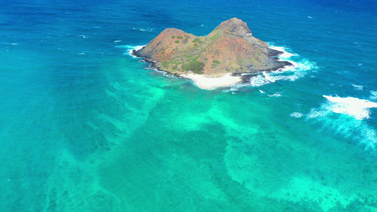 空中拍摄的岛屿海滩对多云的天空，无人机飞行在蓝绿色的海洋-威基基，夏威夷视频素材