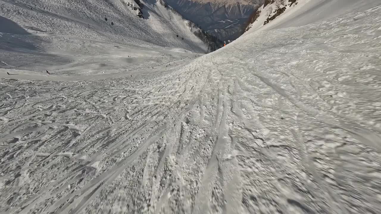 活跃的人们骑着滑雪板在雪山山谷的轨道上全景鸟瞰视频素材