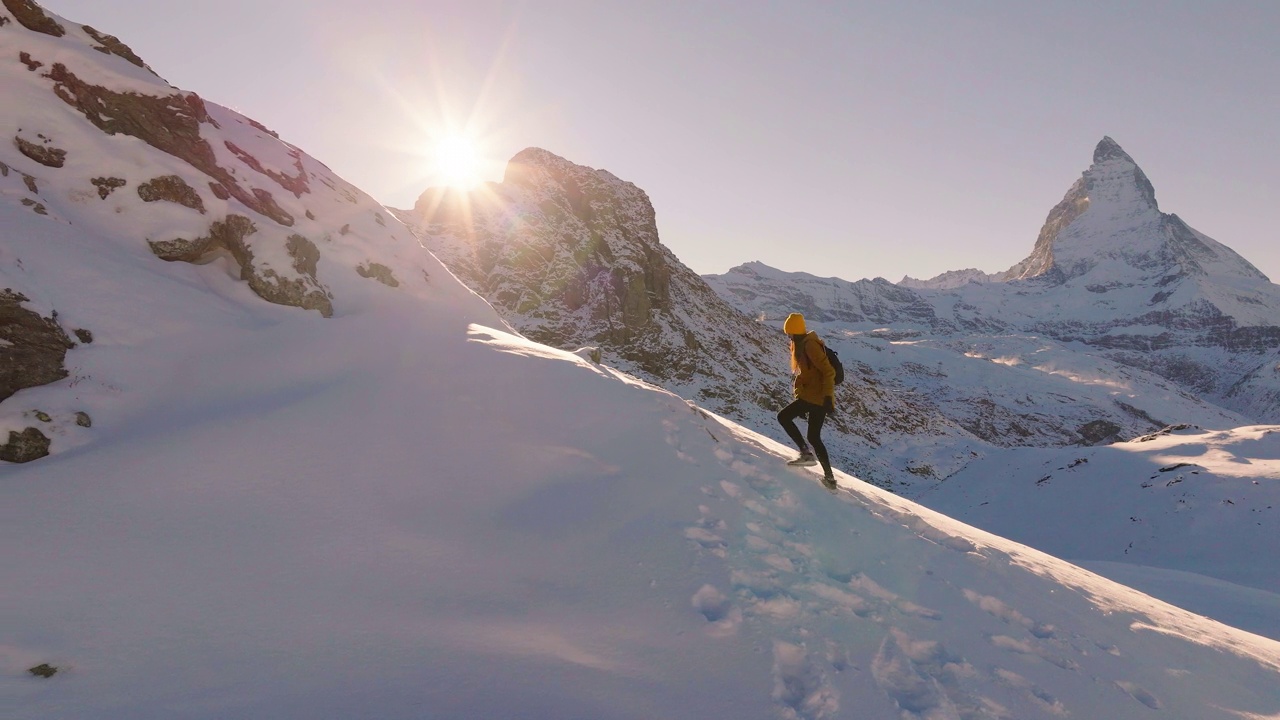 航拍无人机拍摄的年轻女子攀登瑞士马特洪峰山顶的照片。自然中的快乐。多元理念的体验式旅行。与α。视频下载