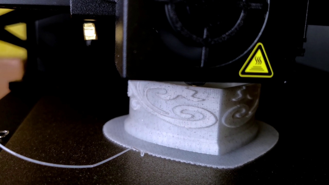 熔融沉积建模3D打印机。打印塑料长丝灰白色心形盒子。工作热塑性材料的特写视图。PLA聚合物沉积宏视频视频下载
