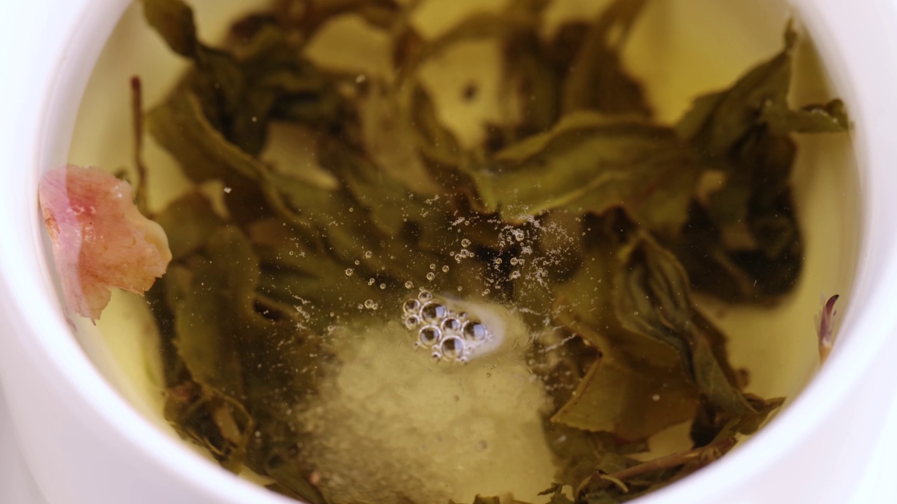 用白色瓷杯冲泡的浓绿茶视频下载