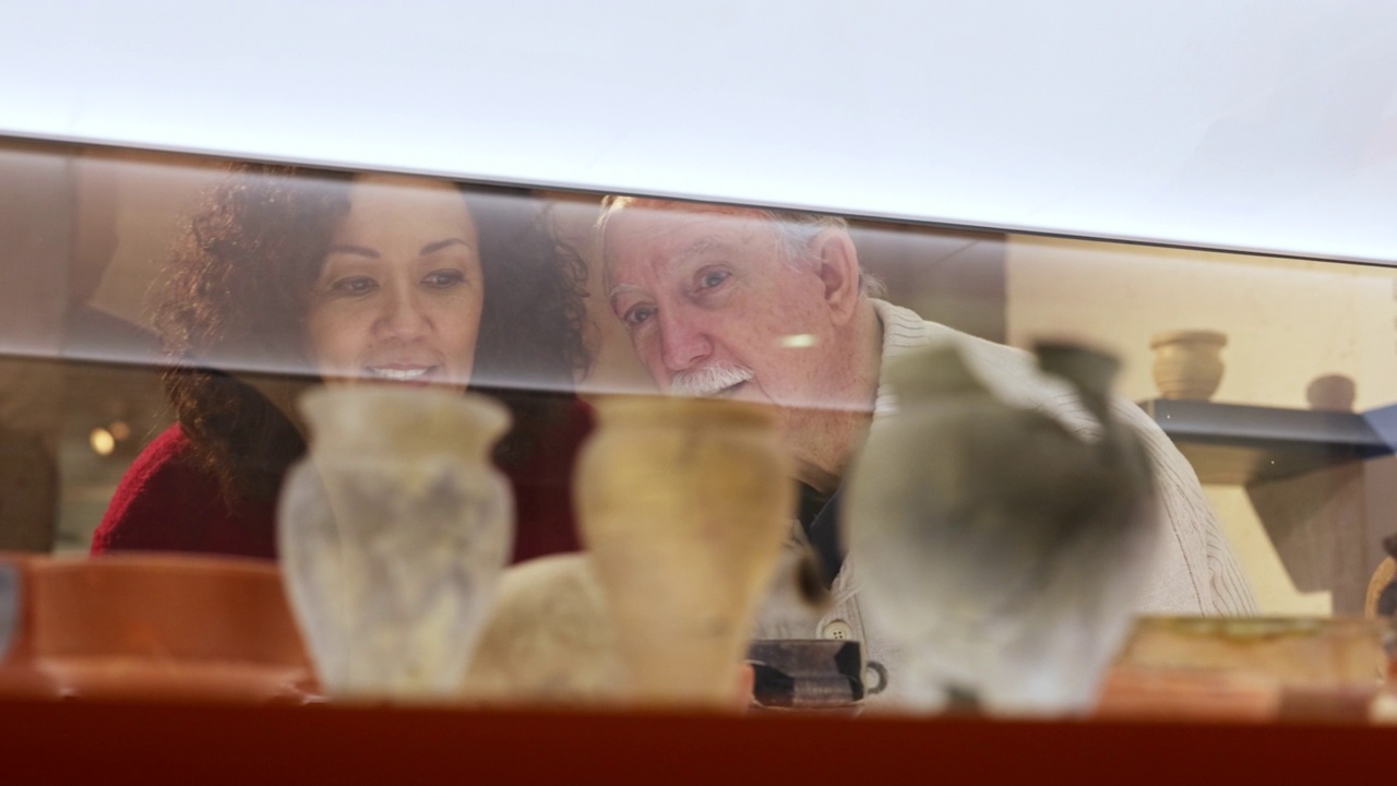 快乐的不同的老年夫妇在历史博物馆看有趣的展品视频下载