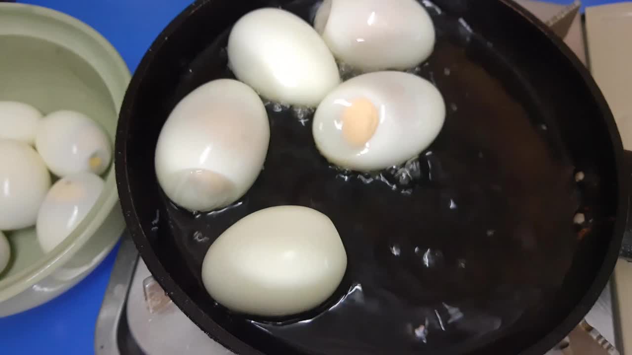 把煮熟的鸡蛋放在锅里煎的镜头视频素材