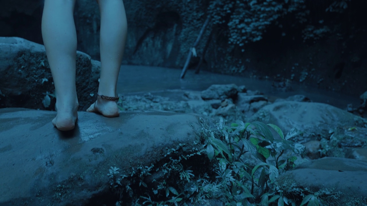 近距离的腿女人看瀑布在热带雨林在黑暗中探索丛林视频下载