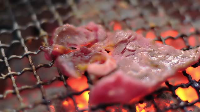 近距离观看牛肉和猪肉切片烧烤，烤肉在木炭烧烤，烧烤或日式日式烧肉。视频素材
