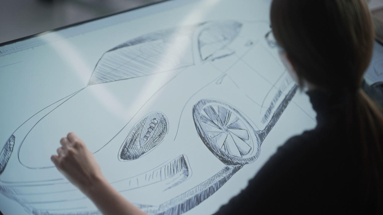 女性汽车设计师使用数字平板电脑用触控笔绘制原型车草图。有才华的工业艺术家在汽车生产厂的研发工作室工作视频下载