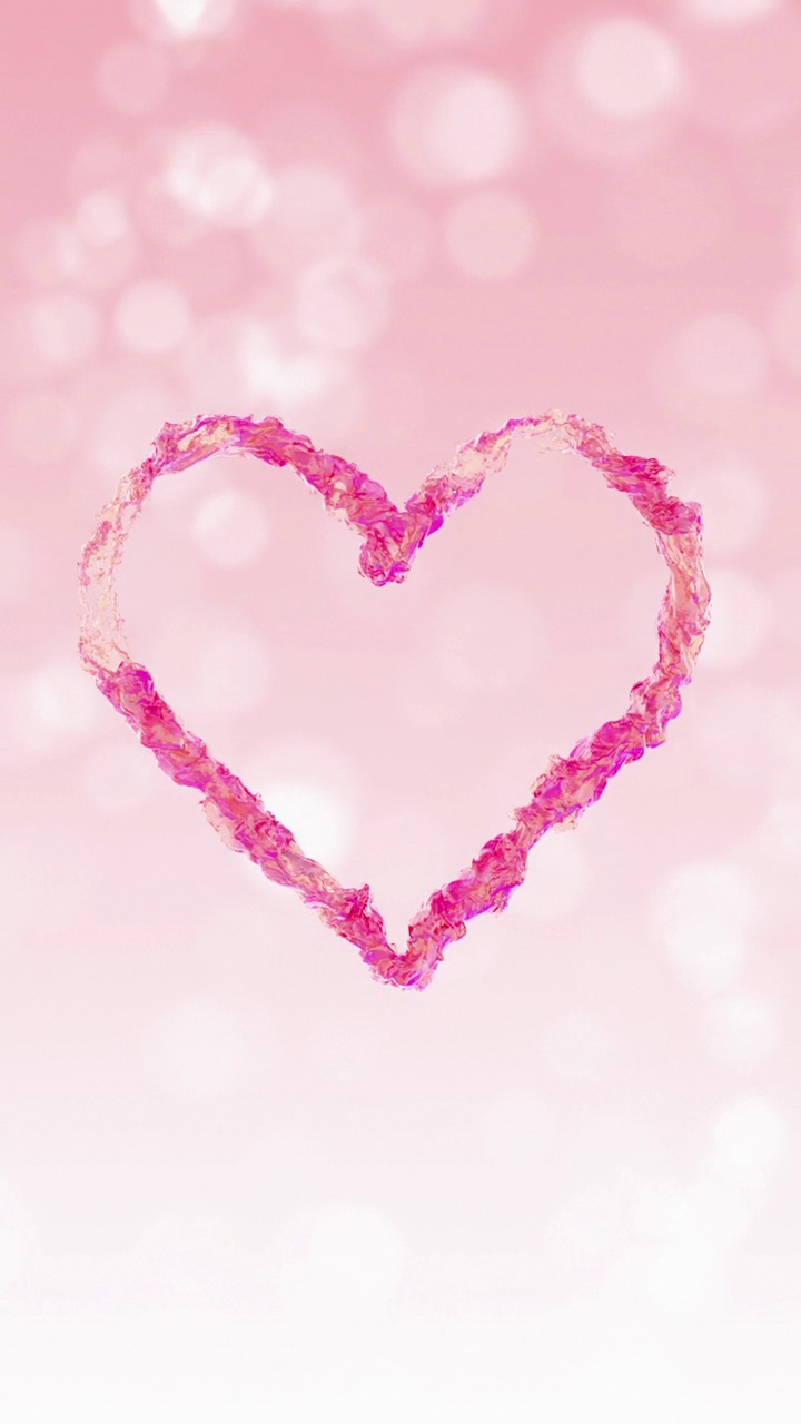 粉色液体心脏在浅粉色散景背景上旋转视频素材