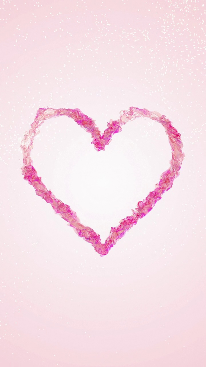 粉红色液体心脏旋转在浅粉色背景与流动粒子视频素材
