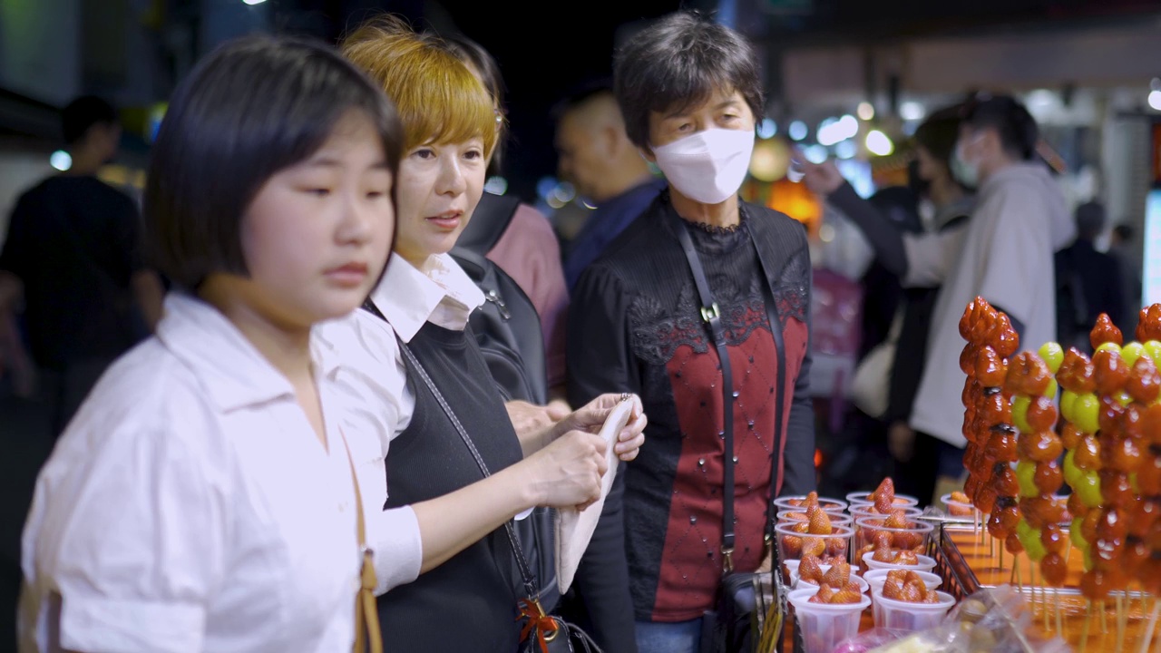 亚洲华人家庭游客在台湾夜市发现街头小吃视频下载