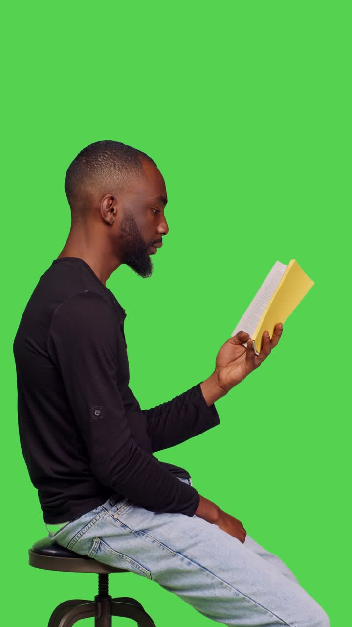 垂直视频:自信的成年人拿着书在镜头前阅读视频下载
