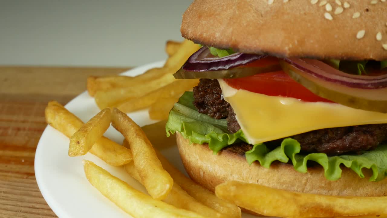 白色盘子里有奶酪和薯条的汉堡视频下载