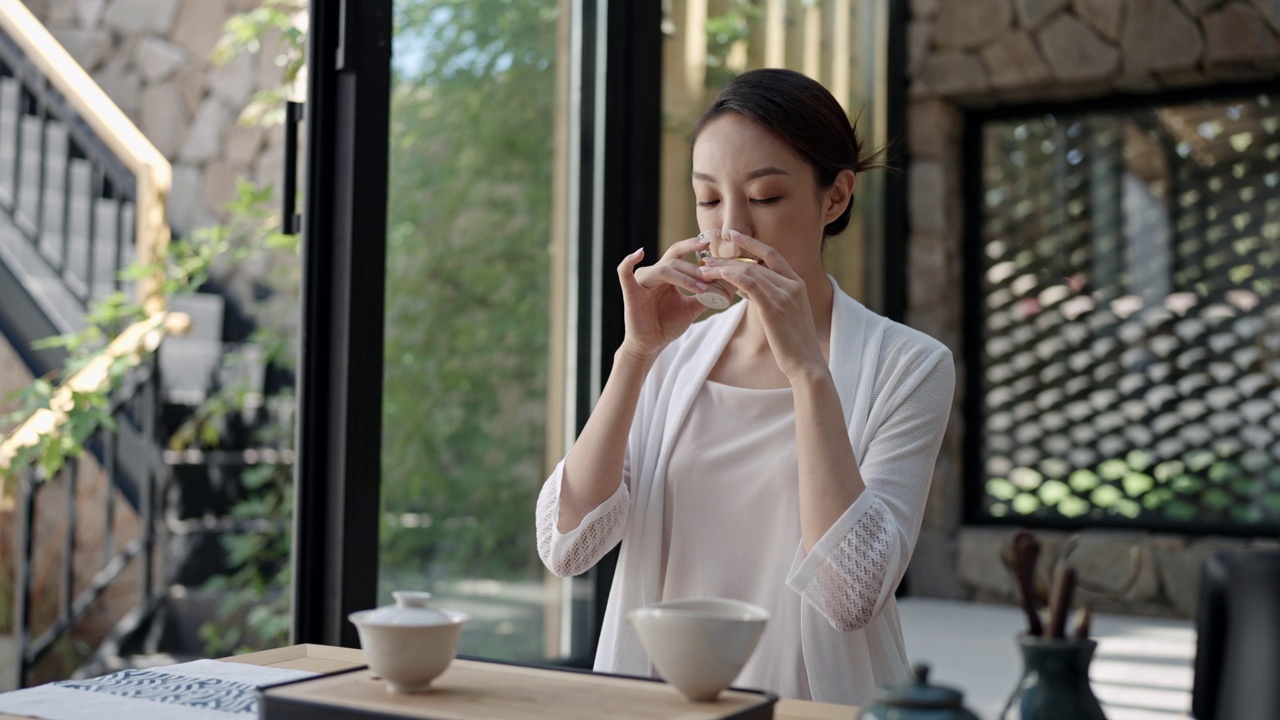 优雅的年轻女子在茶室喝茶，4K视频下载
