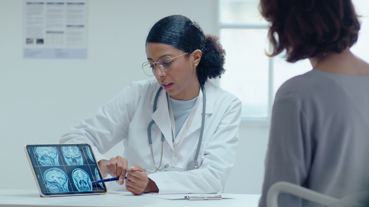 女医生向病人解释数码平板上的MRI扫描视频下载