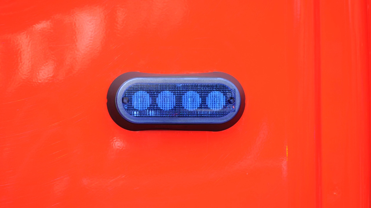 一辆红色应急服务车上闪着蓝灯，微距细节，特写镜头，没人。事故和灾难简单的象征，抽象的概念，没有人，极简主义视频下载