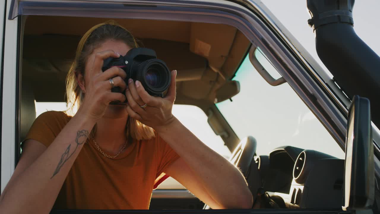 女人，汽车公路旅行和相机的旅行，冒险和日落摄影。度假、假日或汽车旅行的女性人物摄影师，在大自然中拍摄照片，自由地回忆夏天视频下载