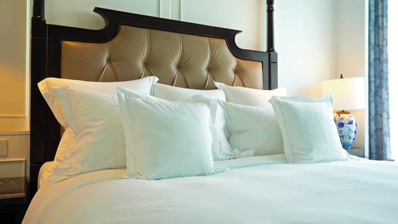 舒适宽敞的豪华酒店特大号床旁边的一个窗口，平移拍摄视频素材