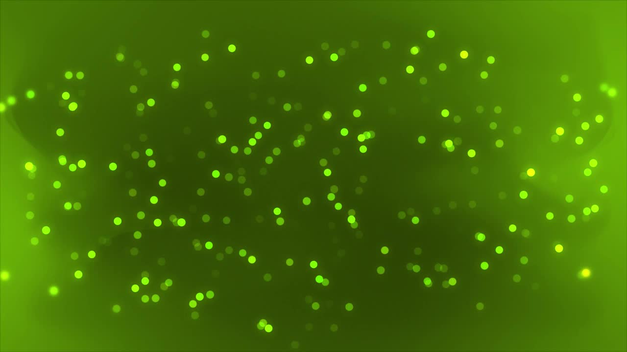 石灰绿色发光的散景粒子优雅的粒子背景。未来主义闪闪发光的颗粒石灰绿色背景视频素材