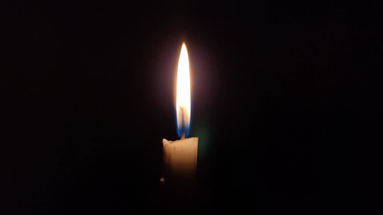 近距离看，黑色背景上燃着一支蜡烛视频下载