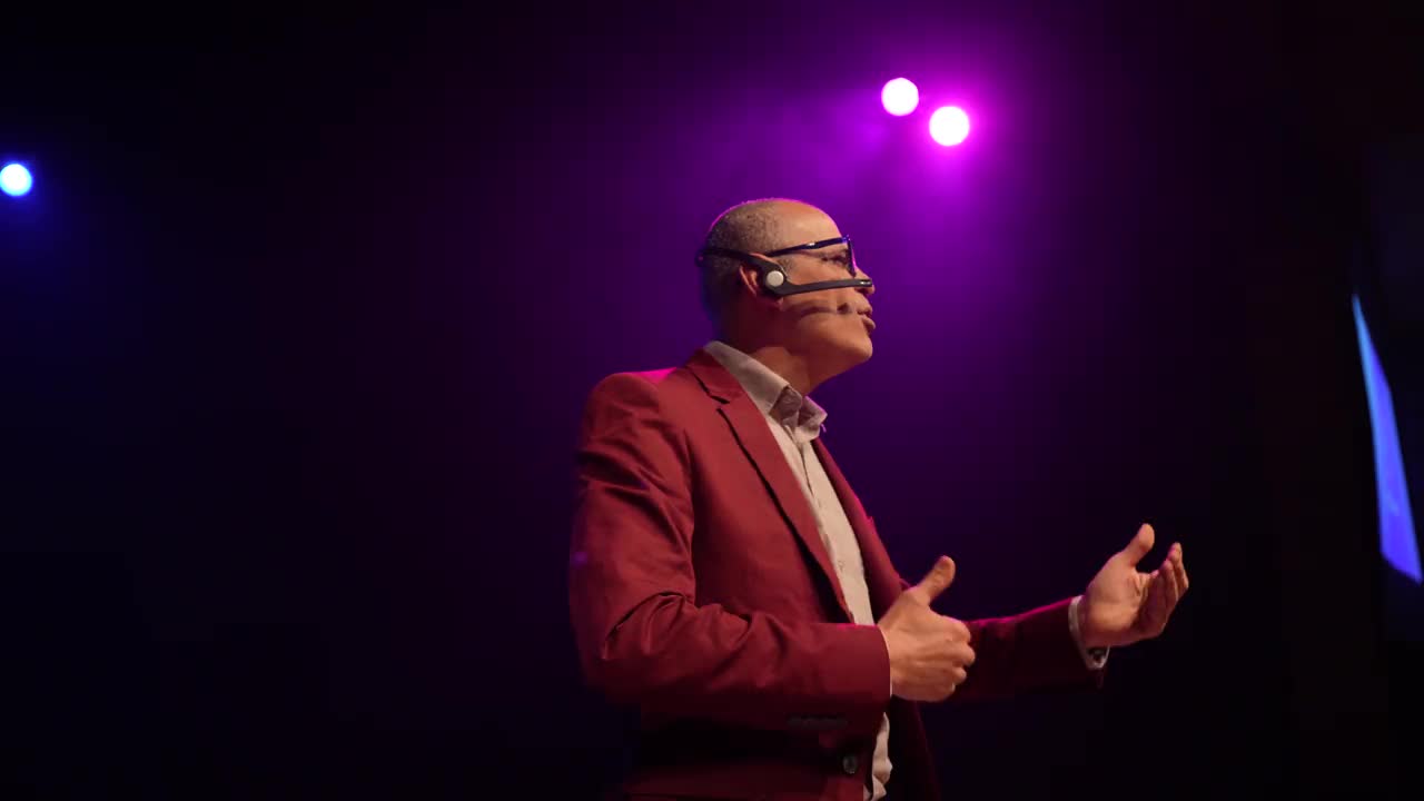 一名西装革履的男子在舞台上用头戴式麦克风讲话视频素材