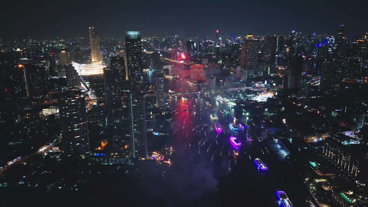 多色烟花在城市和摩天大楼上表演，庆祝夜晚的灯光、河流和曼谷大桥视频下载