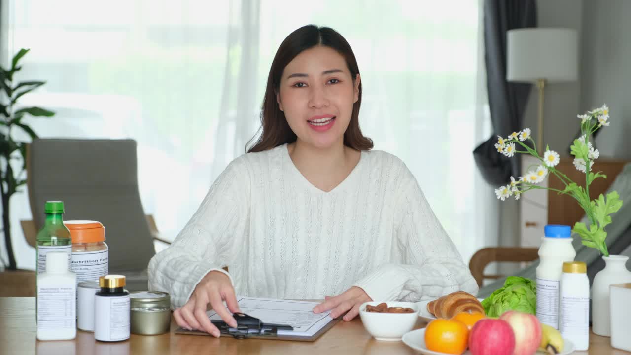 年轻的亚洲女性营养学家给她的客户关于营养的建议，以规划健康的饮食计划视频下载
