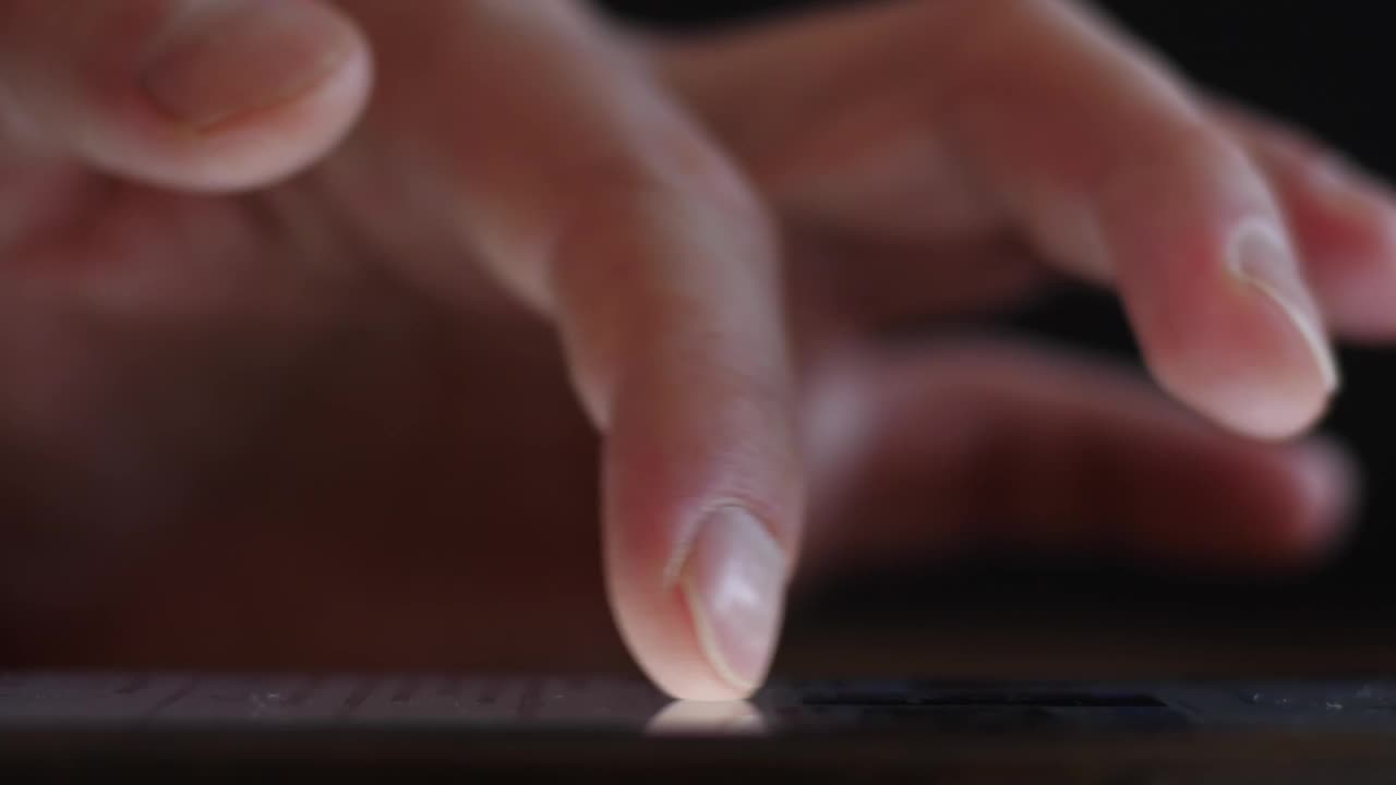 晚上在智能手机上浏览社交媒体，男性的手指在触摸屏上滑动和打字视频下载