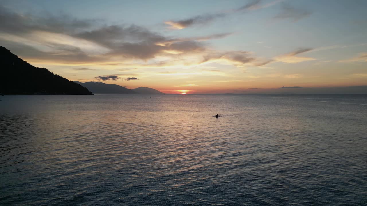 傍晚日落时分，游客在热带地区的海洋中游泳视频下载