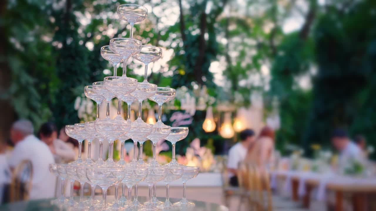 晚上在花园里举行的婚宴上，金字塔形的空香槟酒杯视频下载