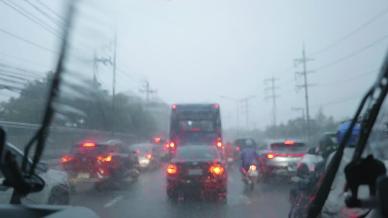 视角:驾驶员看到的被雨水浸透、交通堵塞的道路。曼谷的城市。视频下载