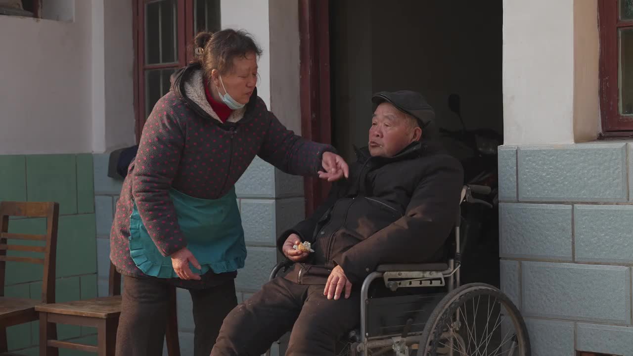 女儿给坐轮椅的父亲喂水果，老人照顾问题视频下载