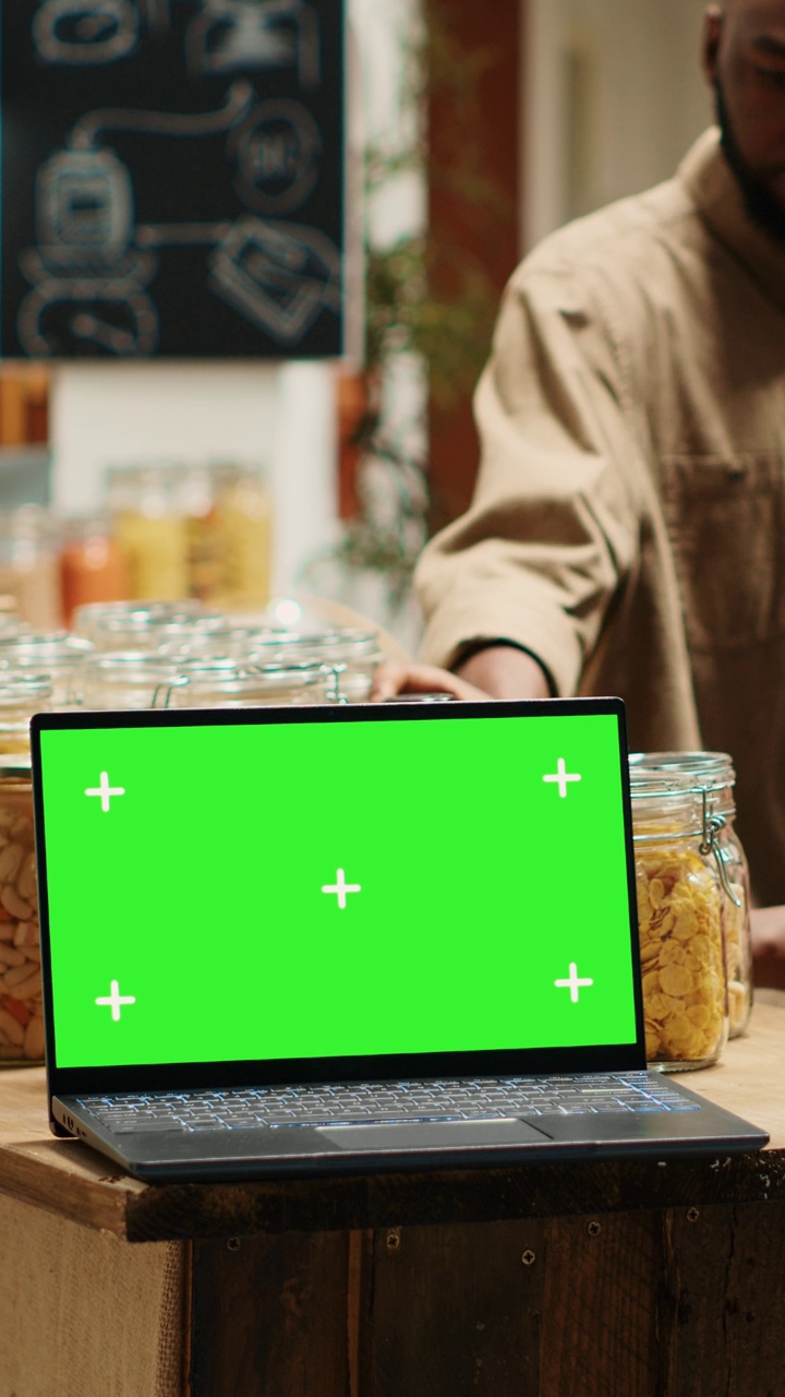 超市摊位上的垂直视频笔记本电脑显示绿屏模板视频下载