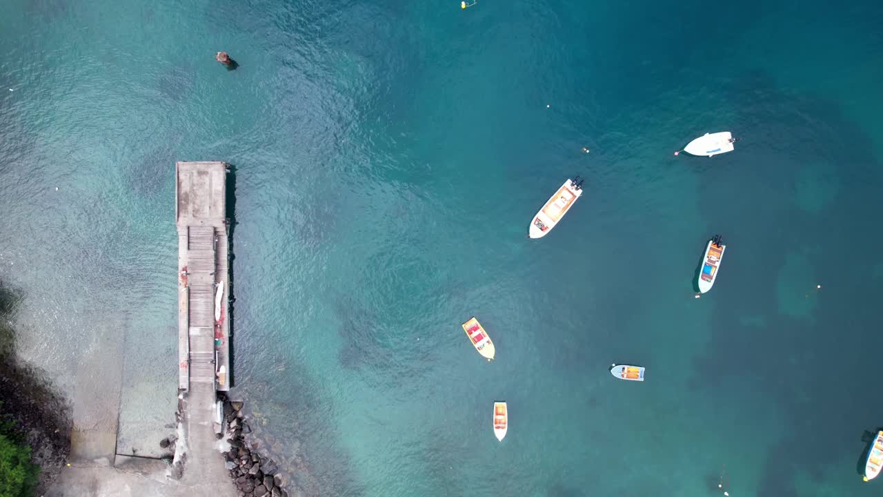 安的列斯群岛瓜德罗普岛的安斯拉巴克湾抛锚的船只和码头。空中自顶向前视频下载