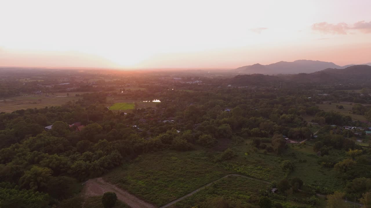 从空中拍摄的鸟瞰日落，那空那育的一个村庄，水从大坝流出，可以看到考艾。这是一条很长的山脉。视频下载
