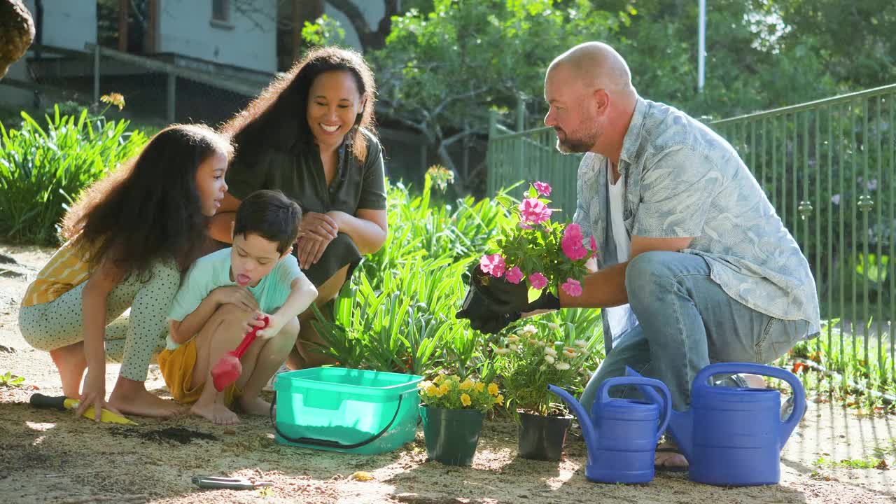 微笑的父母带着孩子在花园里种花视频下载