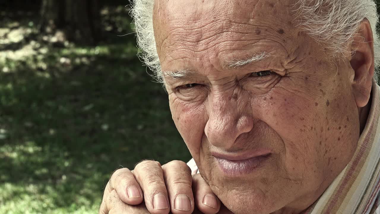 老年人在公园户外的悲伤老人画像:沉思的老人视频下载