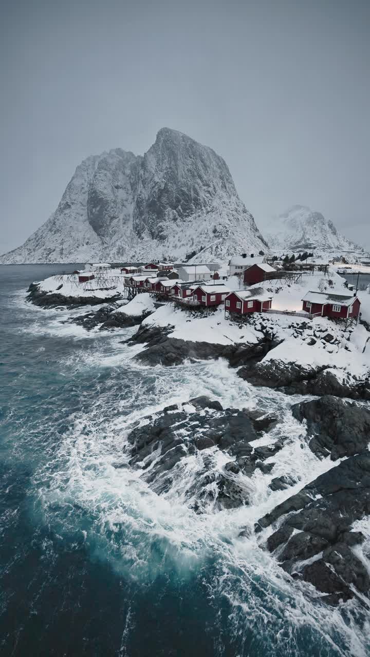 罗弗敦群岛的自然景观，挪威，莱因，红房子渔村在雪山，航空垂直视频视频下载