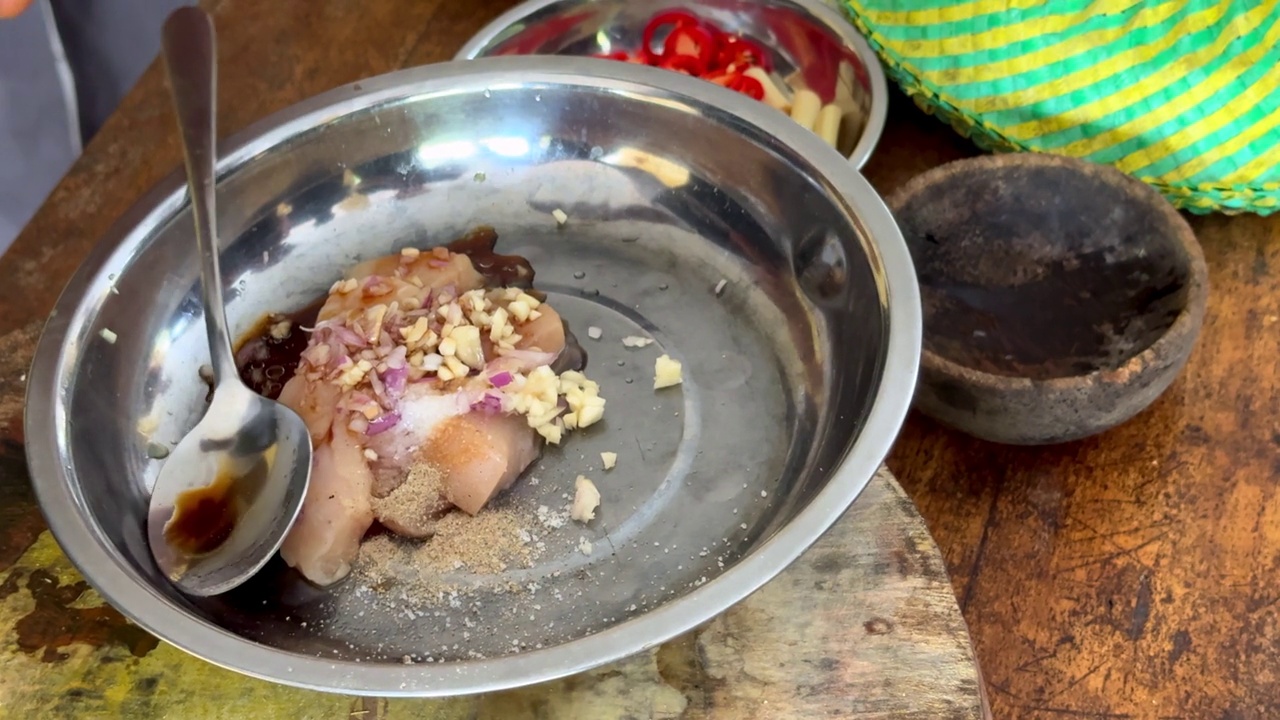 厨师加入老抽调味生鸡肉，洋葱和大蒜准备沙茶鸡肉串作为传统的巴厘岛餐的一部分视频素材