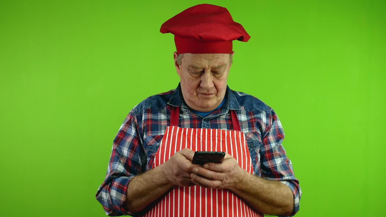 高级厨师用手指在智能手机上快速发短信聊天。视频下载