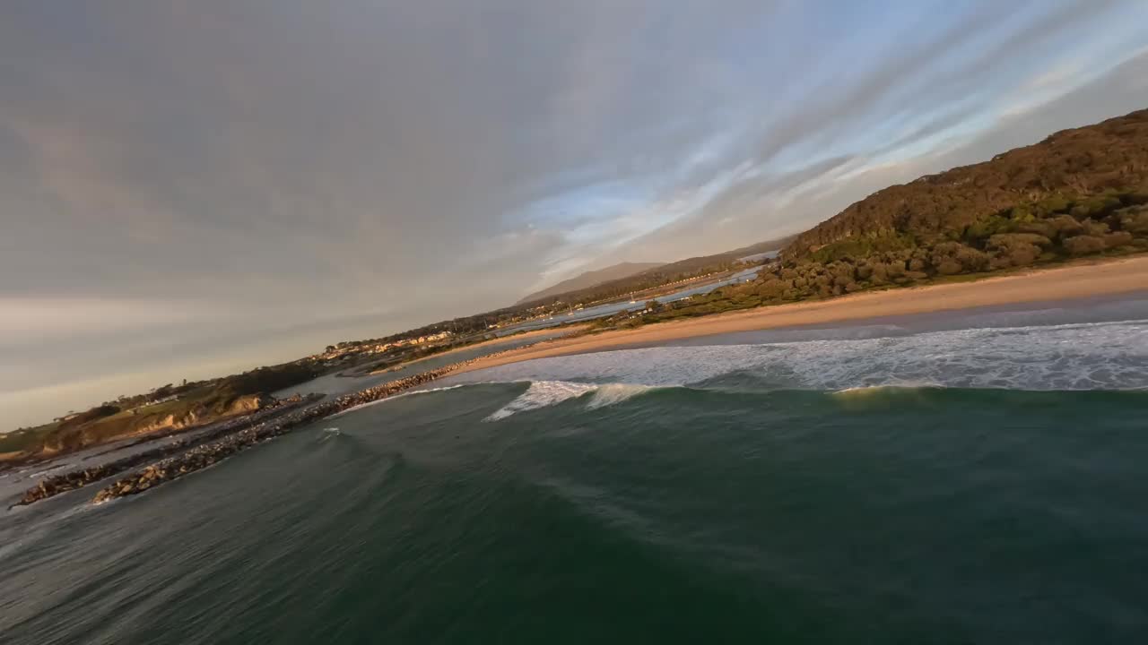 从鸟瞰图上可以看到，日出后，一个冲浪者正在乘风破浪。视频下载
