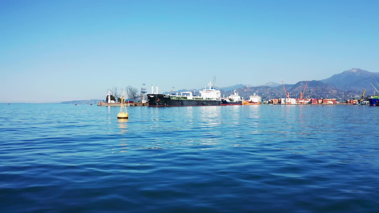 在卸货货船和油气液化石油气(LPG)油轮的工业港，无人机在海面上飞行视频下载