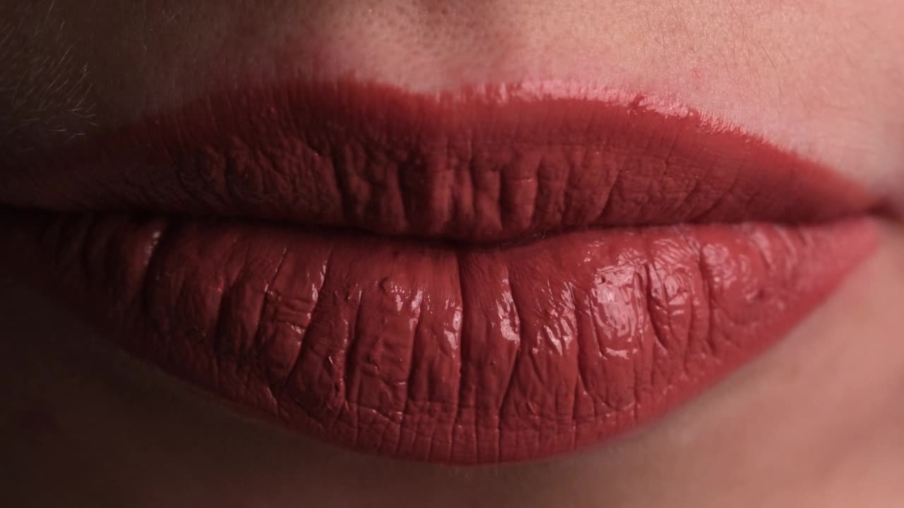 化妆脸部细节，用口红画嘴唇特写，女孩舔她的嘴唇视频下载